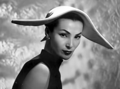 georges-saad-photo-of-albouy-hat-475x353 1952-Lucky-in-hat-inspired-by-those-worn-by-Spanish-Civil-Guard,-is-made-of-white-gros-grain-and-ties-in-the-back-by-Albouy,-photo-by-Georges-Saad