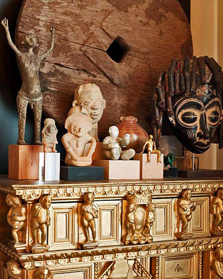 interior-design-eccletic-mix Accessorize-your-Home-african-art-figures with putti relief figure gold cabinet