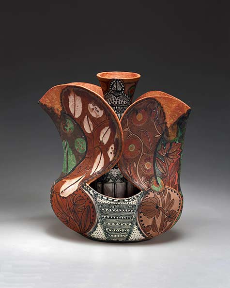 andrea-gill-meadows-gallery ceramic vessel encasing a vase with black and white geometric patterns