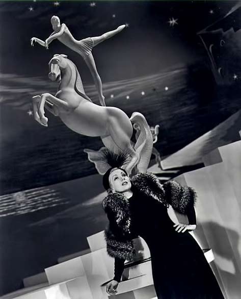 Ann-Sothern,-1939 actress Ann Sothern with circus acrobat on horde statue