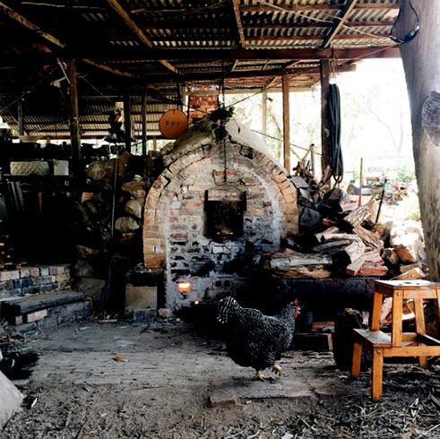 Audrey-the-wood-fire-kiln Audrey-the-wood-fire-kiln in the shed with a black chook