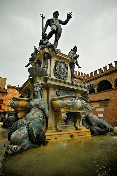 BolognaThe-Fountain-of-Neptune-(Italian-Fontana-di-Nettuno)-is-a-monumental-civic-fountain-located-in-the-eponymous-square,-Piazza-del-Nettuno street Fountain-of-Neptune in Italy