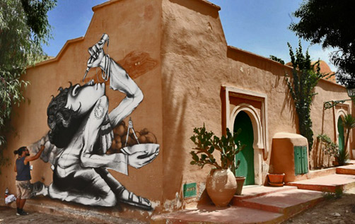 Claudio-Ethos-painting-mural Brazilian-artist-Claudio-Ethos-works-on-his-mural