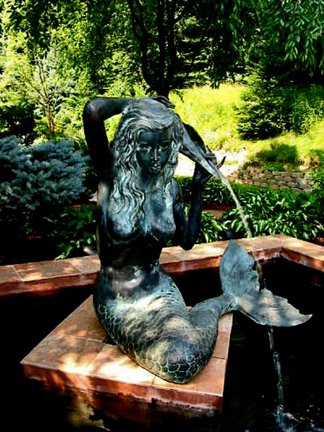 Bronze-mermaid-fountian-in-garden Bronze seated mermaid-fountain in a garden pond