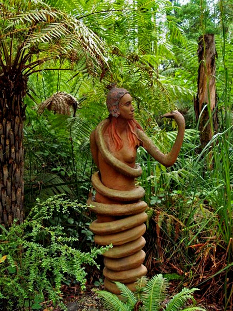 Snake woman-sculpture-Brunos-garden Bruno-Torfs,-sculpture-garden Sculpture of a woman coiled in a snake