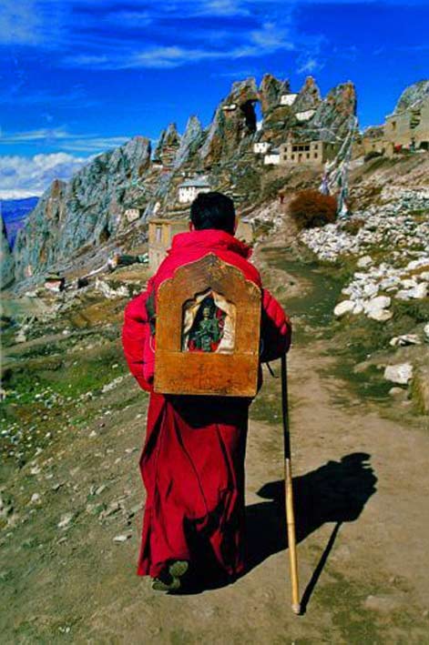 trekking-buddhist-monk Buddhist-monk-carrying Buddha shrine on his back in-Tibet