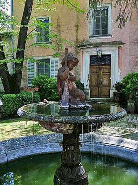 Courtyard-fountain-in-Provence. Cherub sculpture courtyard fountain