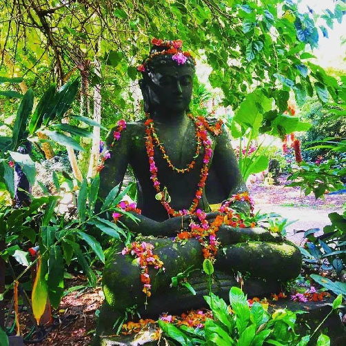 Do-not-dwell-in-the-past,-do-not-dream-of-the-future,-concentrate-the-mind-on-the-present-moment Buddha with garlands