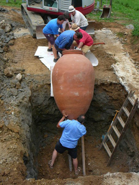 lowering-a-qvevri-pot-into-pit-473x631 Burying a Georgian Qvevri wine pot