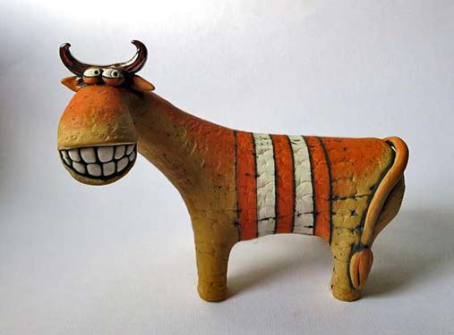 Inna-Olshansky,-smiling-cow Inna Olshansky smiling ceramic cow sculpture with orange and white stripes