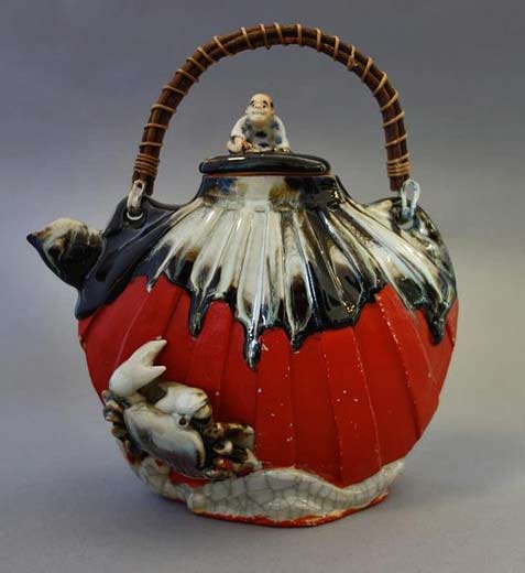 Sumida-Gawa-earthenware-teapot Japanese-Sumida-Gawa-earthenware-teapot.-The-finial-depicts-a-seated-male-figure.-Raised-crab-and-sea-motif.