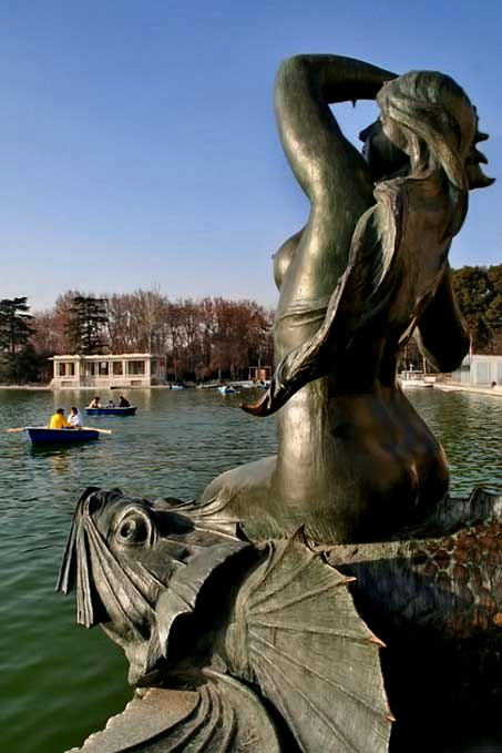mermaid-statue-sculpture-madrid-spain Seated mermaid-statue next to a lake - sculpture Madrid, Spain