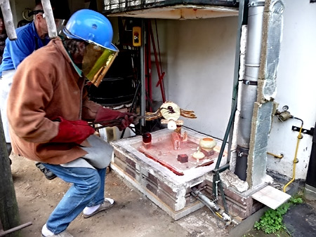 Phillipe-with-tongs-450x338.jpg removing raku pottery from kiln with tongs