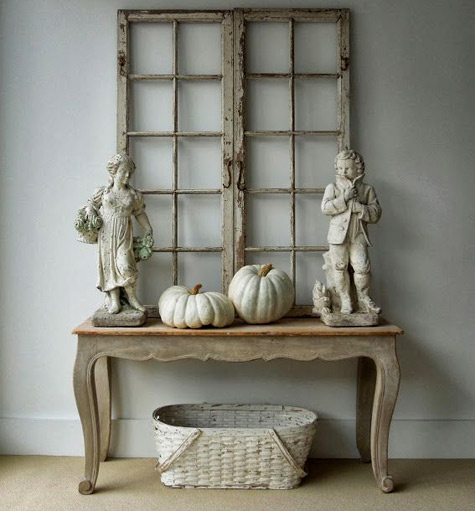 lumina-pumpkins-Swedish-windows-garden-statues pair-of-18th-century-Swedish-windows,-garden-statues-depicting-the-seasons,-and-two-Lumina-pumpkins-on-a-French-painted-console.