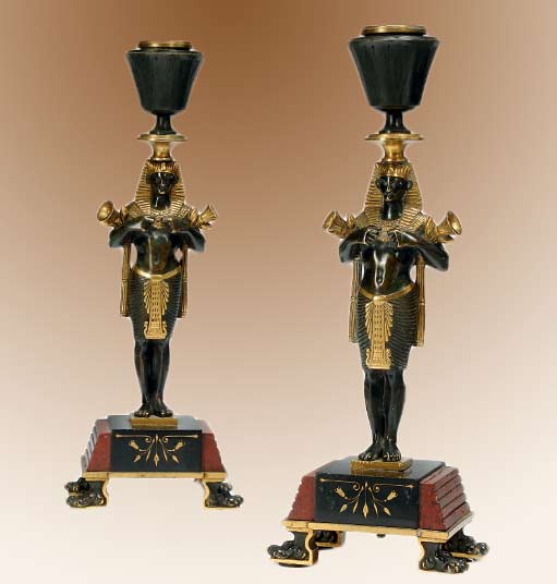 Egytpian-styled-candle-holders Pair-of-French-gilt-and-patinated-Egytpian-styled-candle stands
