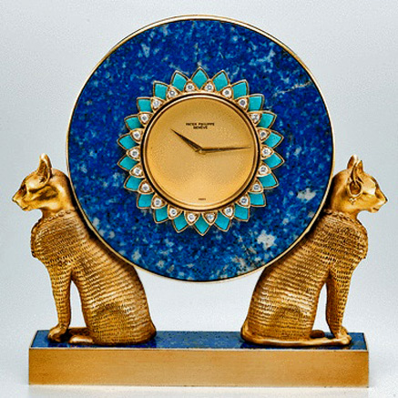 phillipe-patek-lapis-lazuli-table-clock-437x437 PATEK-PHILIPPE,-A-FINE-AND-UNIQUE-GOLD,-LAPIS-LAZULI,-TURQUOISE-AND-DIAMOND-SET-MINIATURE-EGYPTIAN-STYLE-TABLE-CLOCK-with twin cats 1978-