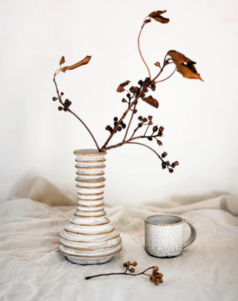 Vase-and-Mug-Nicolette-Johnson Horizontal ribbed white ceramic vase, dried flowers and cup --- Nicolette Johnson