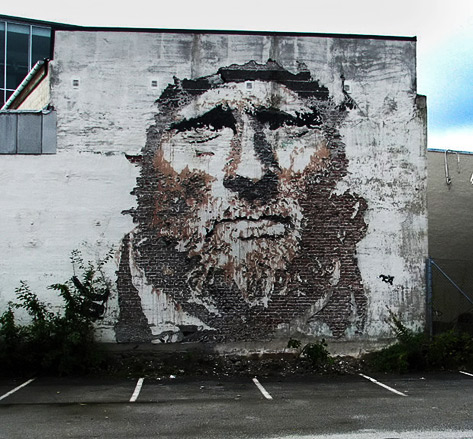 Portuguese-muralist-Vhils Vhils wall portarit using etching, tearing or acid-burning of the surface