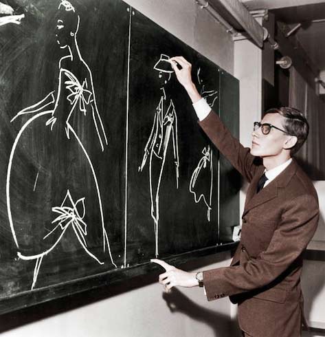 Yves-Saint-Laurent-Paris-designer We-must-never-confuse-elegance-with-snobbery - Yves Saint Laurent sketching designs on a blackboard