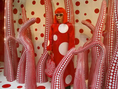 Yayoi-Kusama-Gallery Yayoi-Kusama-Gallery-----red and white octopus tentacles surrounding Yayoi in a polka dot dress